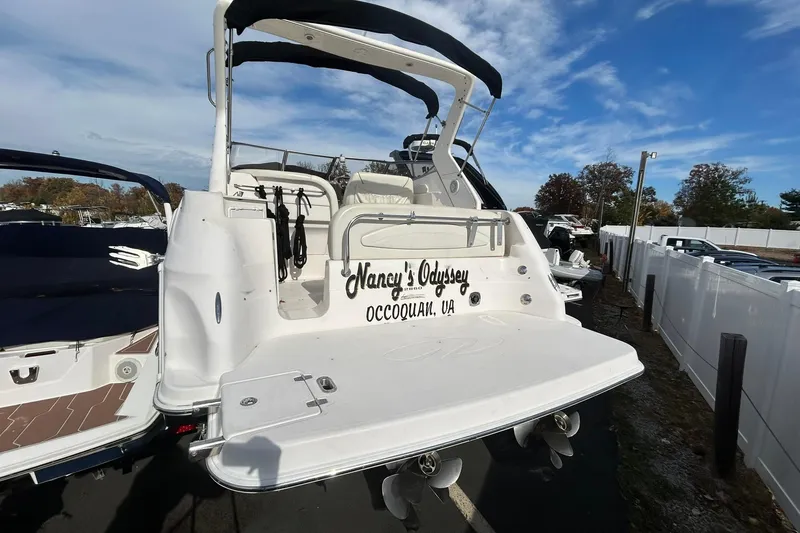 Slide: The Image of 2004 Regal Commodore 2860 boat docked, featuring "Nancy's Odyssey" name on the stern. - 6