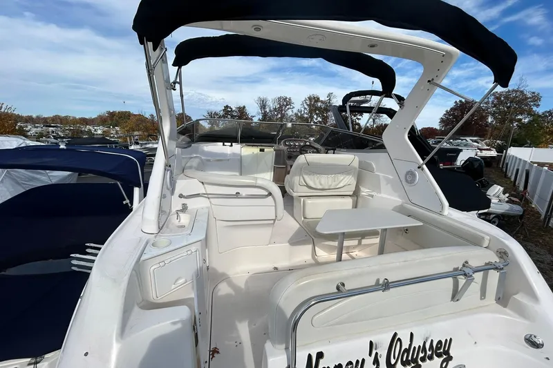 Slide: The Image of 2004 Regal Commodore 2860 boat with seating and table, docked outdoors. - 7