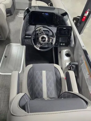 Slide: The Image of 2025 Barletta Boats R23UCA cockpit with modern steering and dashboard controls. - 7