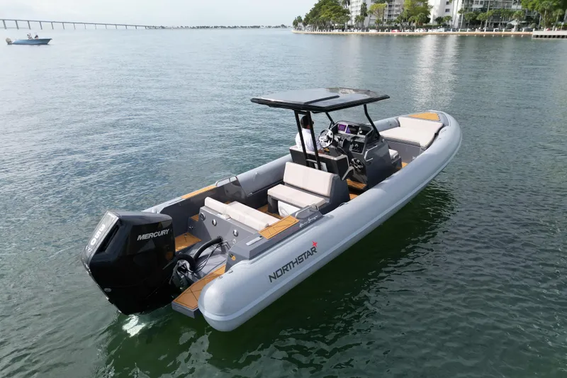 Slide: The Image of 2026 Northstar Orion 8 boat on calm water, featuring Mercury engine and sleek design. - 1