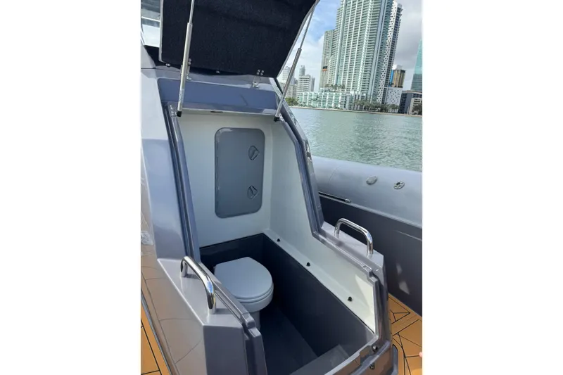 Slide: The Image of Interior view of 2026 Northstar Orion 8 boat's compact bathroom with cityscape background. - 16