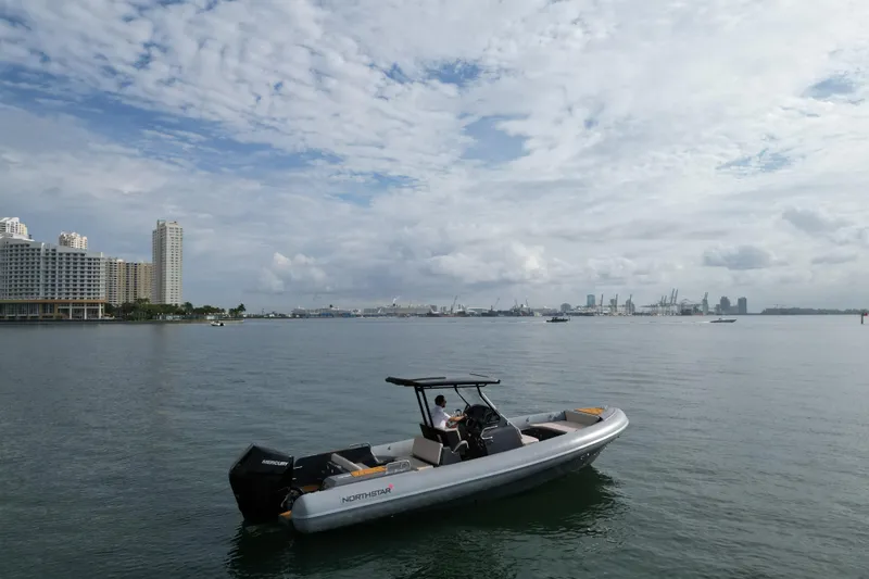 Slide: The Image of 2026 Northstar Orion 8 boat on calm water with city skyline background. - 4