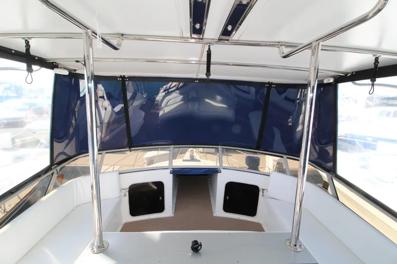 Slide: The Image of 1990 Carver 3467 Santego boat interior with blue canopy and seating area. - 10
