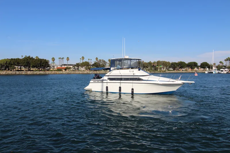 Slide: The Image of 1990 Carver 3467 Santego yacht cruising on a sunny day in a calm harbor. - 2