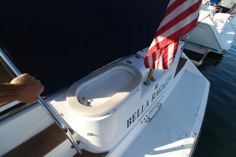 Slide: The Image of 1990 Carver 3467 Santego boat with American flag and "Bella Ricci" name on deck. - 20