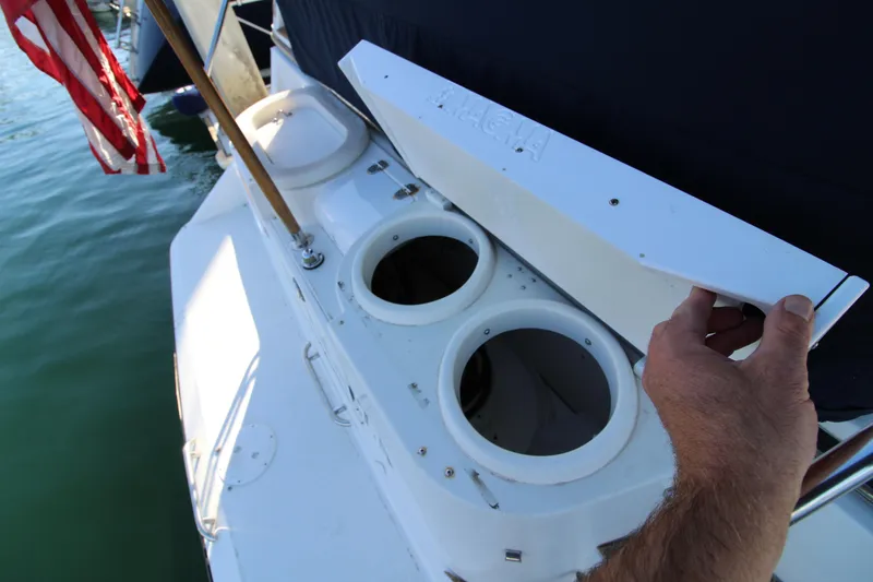 Slide: The Image of 1990 Carver 3467 Santego boat with open storage compartments on deck. - 23