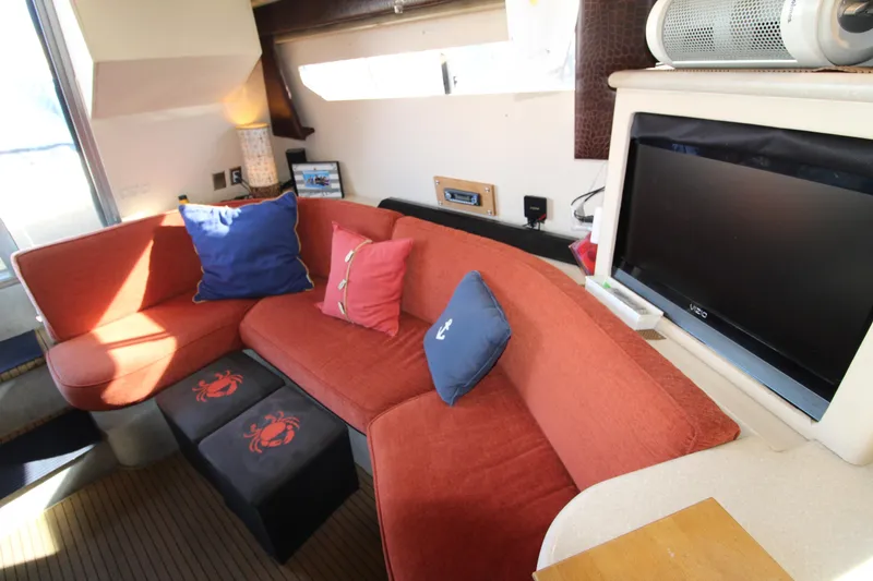 Slide: The Image of Interior of 1990 Carver 3467 Santego yacht with red seating and blue cushions. - 25