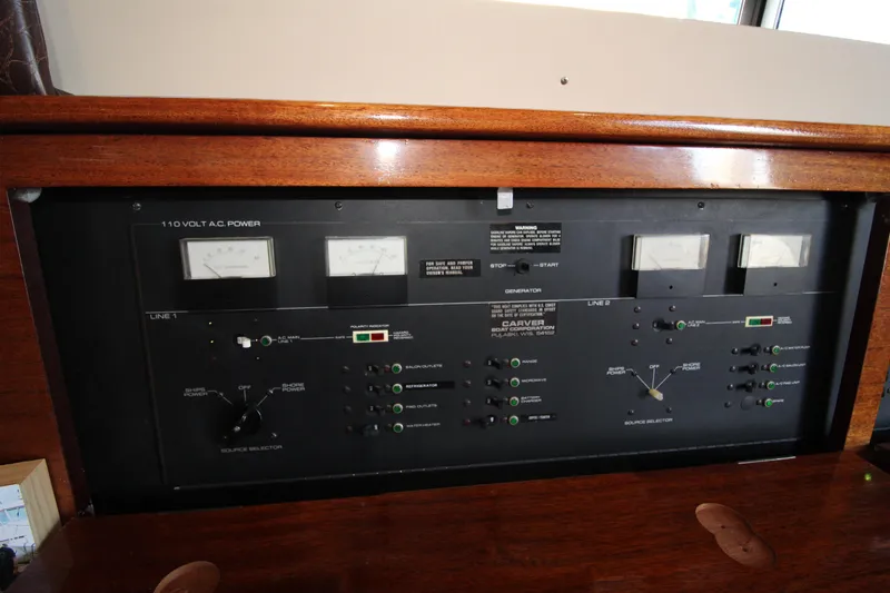 Slide: The Image of Electrical control panel of a 1990 Carver 3467 Santego boat, featuring gauges and switches. - 27