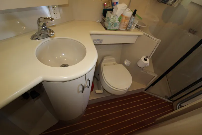 Slide: The Image of 1990 Carver 3467 Santego yacht bathroom with sink, toilet, and shower. - 32