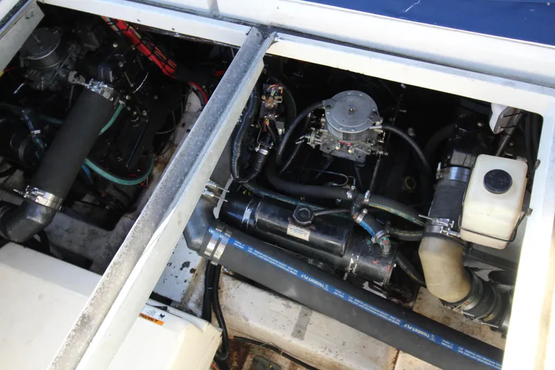 Slide: The Image of Engine compartment of a 1990 Carver 3467 Santego boat, showcasing mechanical components. - 33