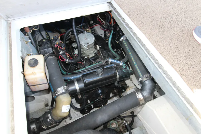 Slide: The Image of Engine compartment of a 1990 Carver 3467 Santego boat, showcasing mechanical components. - 34