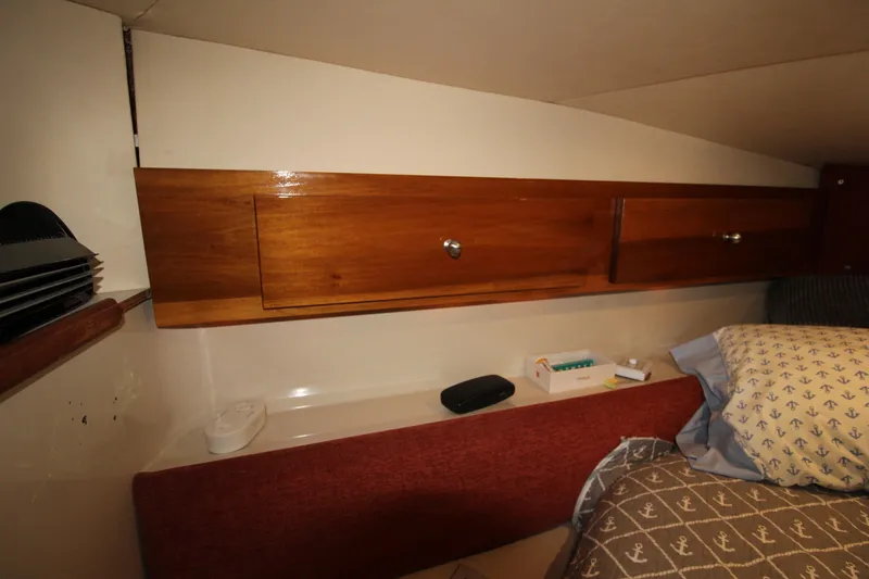 Slide: The Image of 1990 Carver 3467 Santego cabin interior with wooden cabinets and bedding. - 36
