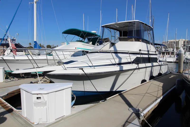 Slide: The Image of 1990 Carver 3467 Santego yacht docked at marina under clear blue sky. - 5