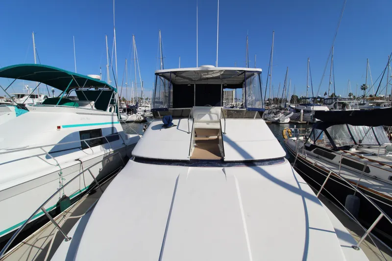 Slide: The Image of 1990 Carver 3467 Santego yacht docked at marina, surrounded by other boats. - 6