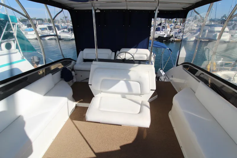 Slide: The Image of 1990 Carver 3467 Santego yacht interior with white seating and steering wheel. - 8