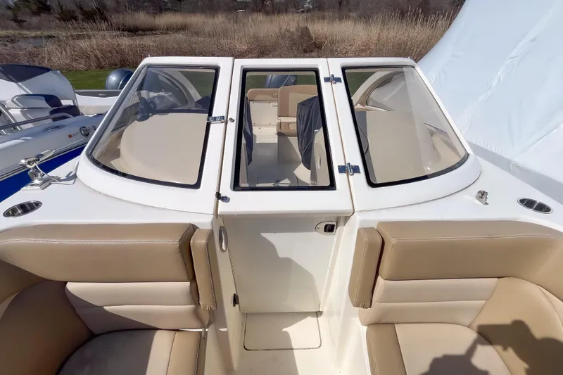 Slide: The Image of 2021 Scout 240 Dorado boat interior with beige seating and windshield. - 11