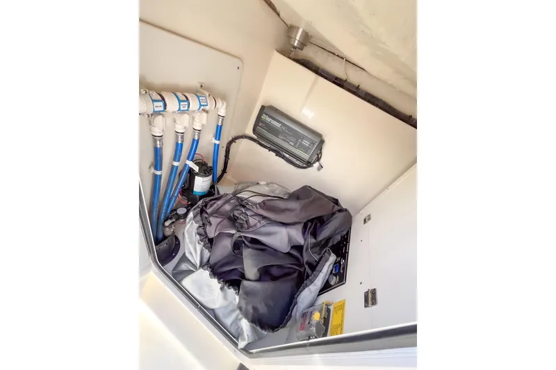 Slide: The Image of 2021 Scout 240 Dorado boat storage compartment with wiring and equipment. - 7