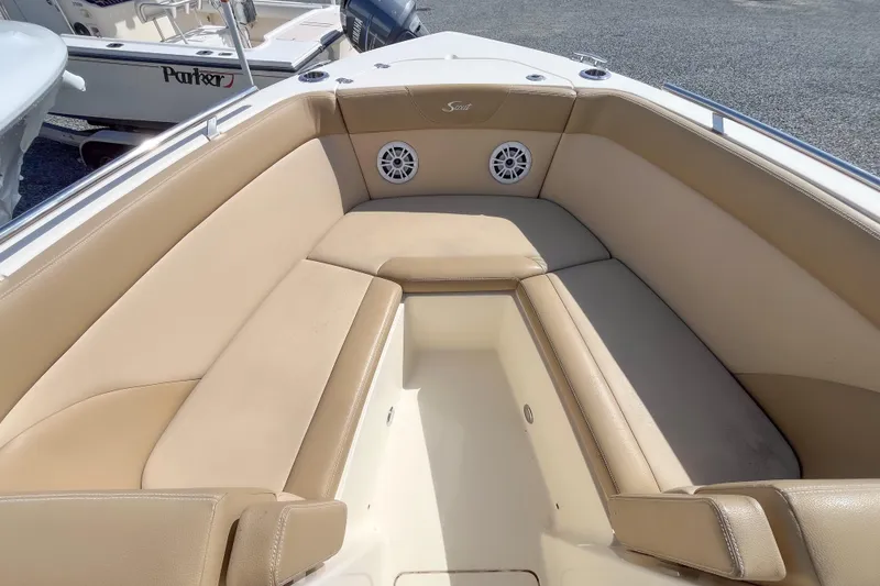 Slide: The Image of 2021 Scout 240 Dorado boat interior with beige seating and speakers. - 9