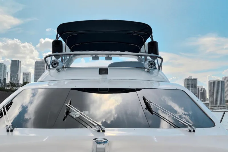 Slide: The Image of 2010 Azimut 62 Evolution yacht with city skyline and blue sky background. - 12