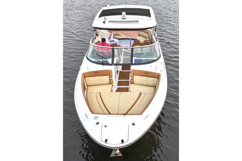 Slide: The Image of 2015 Sea Ray 350 SLX boat with spacious seating on calm water. - 13