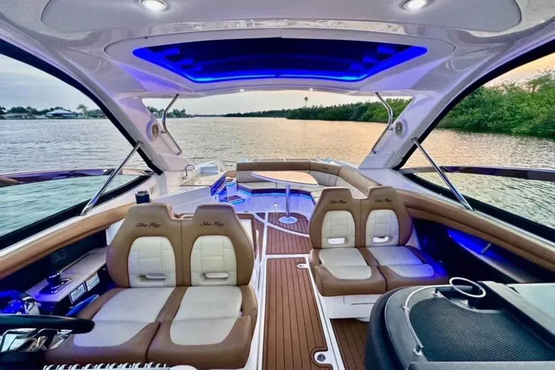 Slide: The Image of Luxurious 2015 Sea Ray 350 SLX boat interior with ambient blue lighting on a serene waterway. - 15