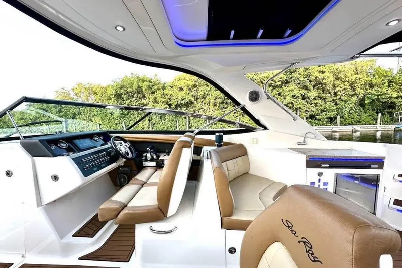 Slide: The Image of Luxurious 2015 Sea Ray 350 SLX boat interior with modern dashboard and seating. - 16