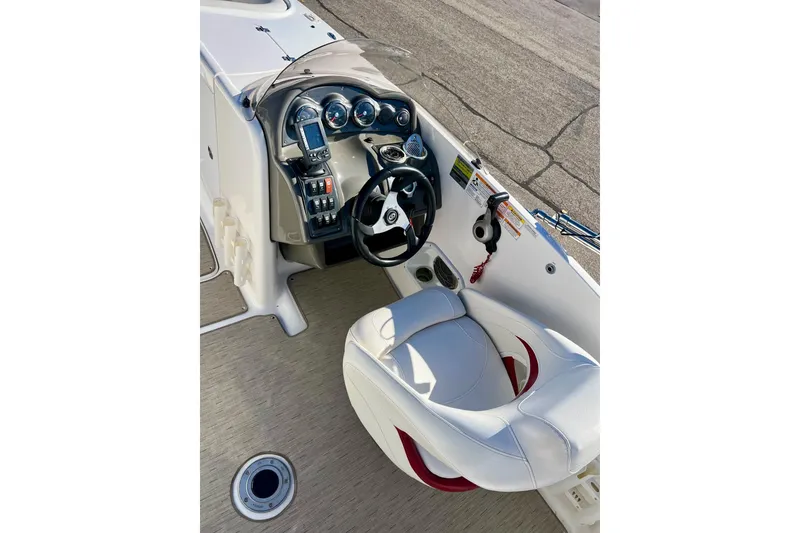 Slide: The Image of 2013 Hurricane SunDeck Sport 220 OB boat cockpit with steering wheel and controls. - 15