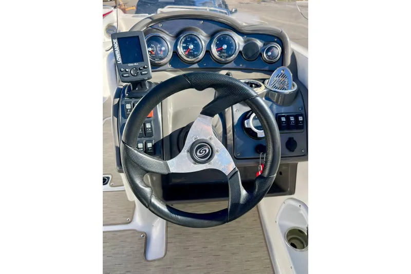 Slide: The Image of Steering console of 2013 Hurricane SunDeck Sport 220 OB with gauges and controls. - 16