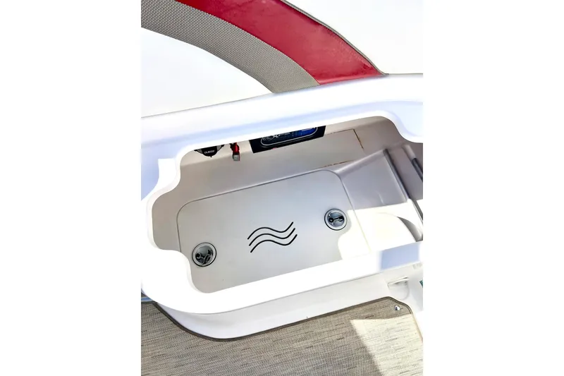 Slide: The Image of 2013 Hurricane SunDeck Sport 220 OB storage compartment with wave design. - 25