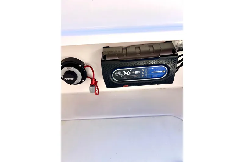 Slide: The Image of 2013 Hurricane SunDeck Sport 220 OB battery switch and charger setup. - 27