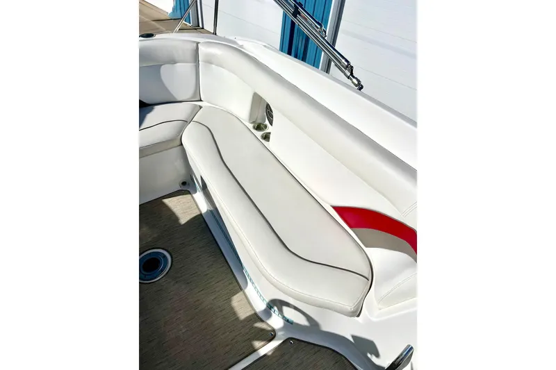 Slide: The Image of 2013 Hurricane SunDeck Sport 220 OB boat interior with white seating and red accents. - 28