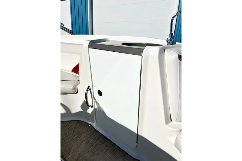 Slide: The Image of 2013 Hurricane SunDeck Sport 220 OB interior detail with white seating and storage compartment. - 31
