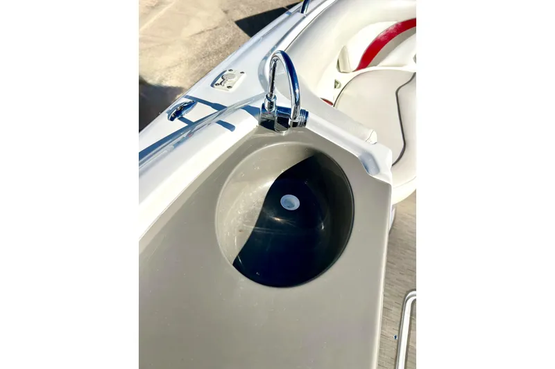 Slide: The Image of 2013 Hurricane SunDeck Sport 220 OB boat sink detail with chrome faucet. - 32