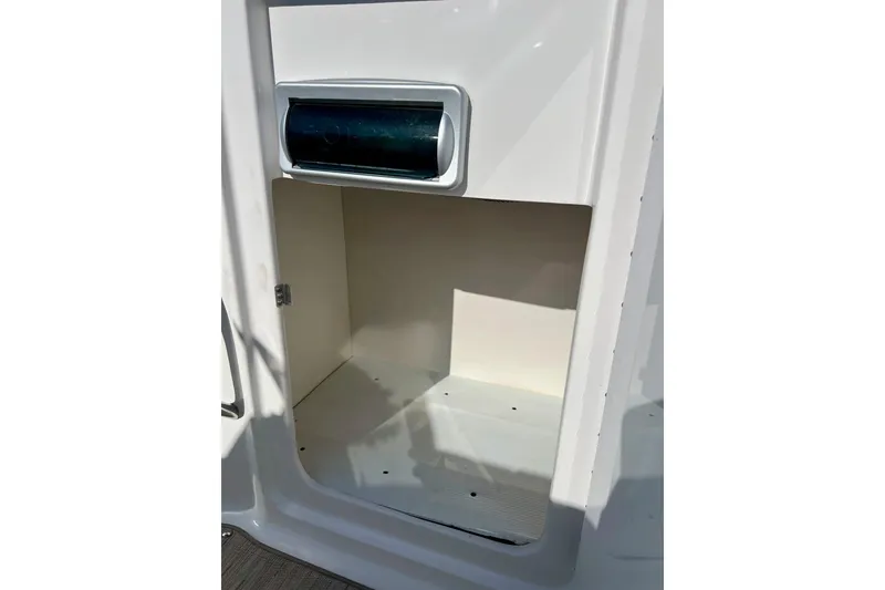 Slide: The Image of 2013 Hurricane SunDeck Sport 220 OB storage compartment, open and empty. - 33