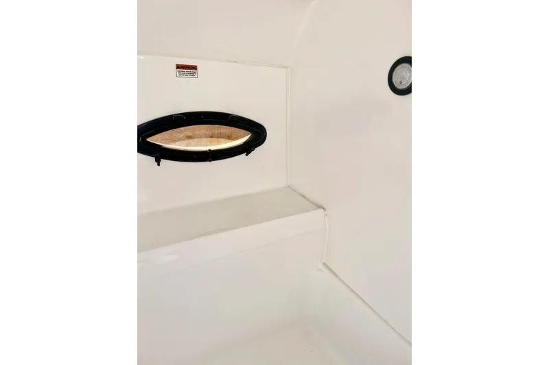 Slide: The Image of Interior view of 2013 Hurricane SunDeck Sport 220 OB boat, featuring a small window. - 38