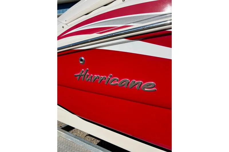 Slide: The Image of 2013 Hurricane SunDeck Sport 220 OB boat with red and white design. - 5