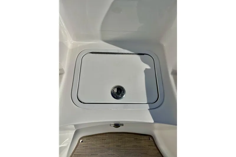 Slide: The Image of Hurricane SunDeck Sport 220 OB 2013 boat storage compartment with latch. - 50
