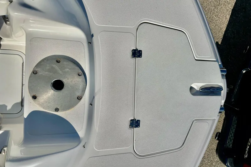 Slide: The Image of 2013 Hurricane SunDeck Sport 220 OB boat deck with storage compartments and metal fixture. - 55