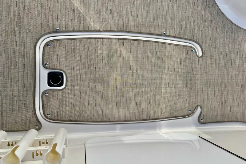 Slide: The Image of 2013 Hurricane SunDeck Sport 220 OB boat interior detail with textured panel and rod holders. - 57