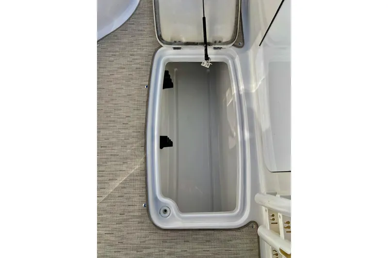 Slide: The Image of Open storage compartment on 2013 Hurricane SunDeck Sport 220 OB boat. - 58