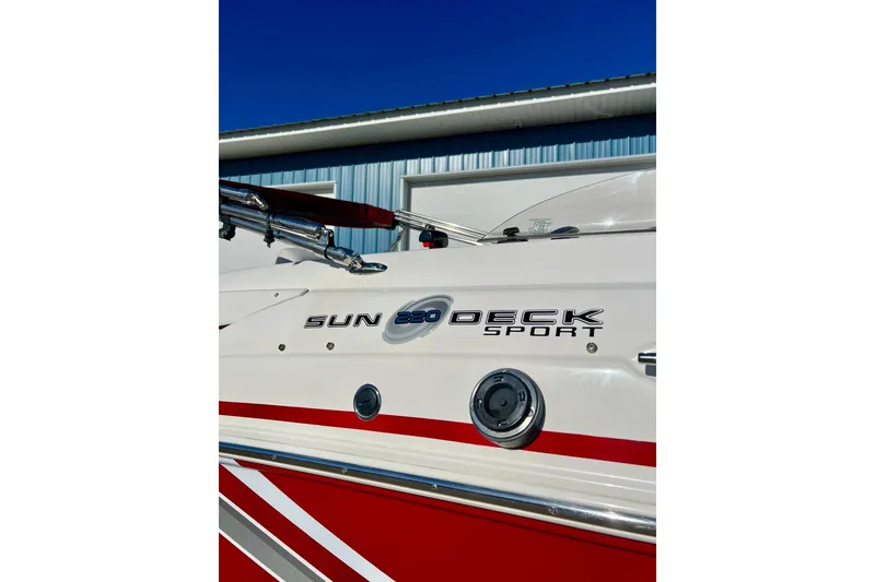 Slide: The Image of 2013 Hurricane SunDeck Sport 220 OB boat with red and white design, side view. - 6
