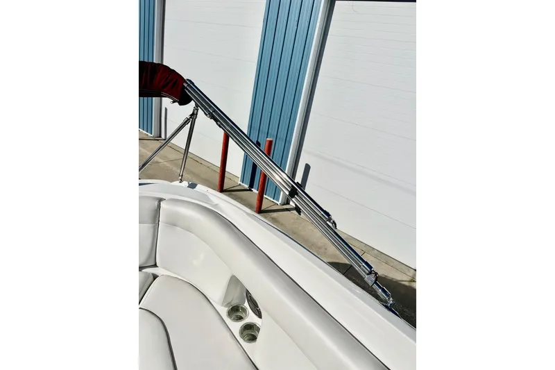 Slide: The Image of 2013 Hurricane SunDeck Sport 220 OB boat interior with white seating and metal railing. - 62