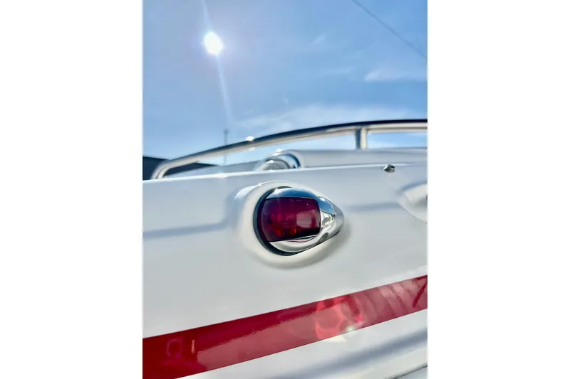 Slide: The Image of 2013 Hurricane SunDeck Sport 220 OB boat detail with red light and railing. - 67