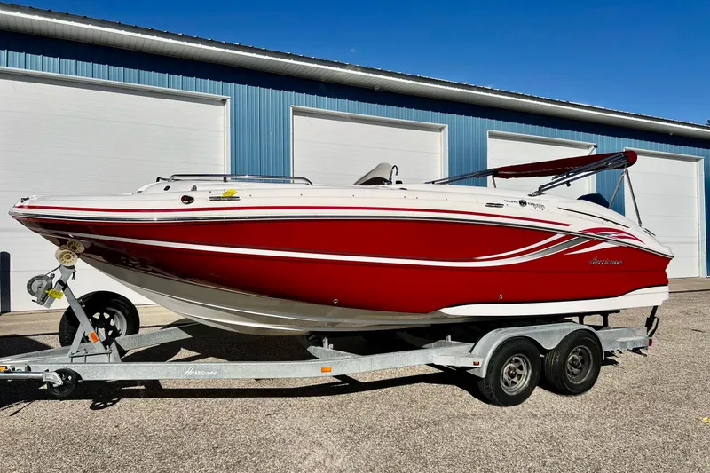 Slide: The Image of 2013 Hurricane SunDeck Sport 220 OB boat in red and white on a trailer. - 72