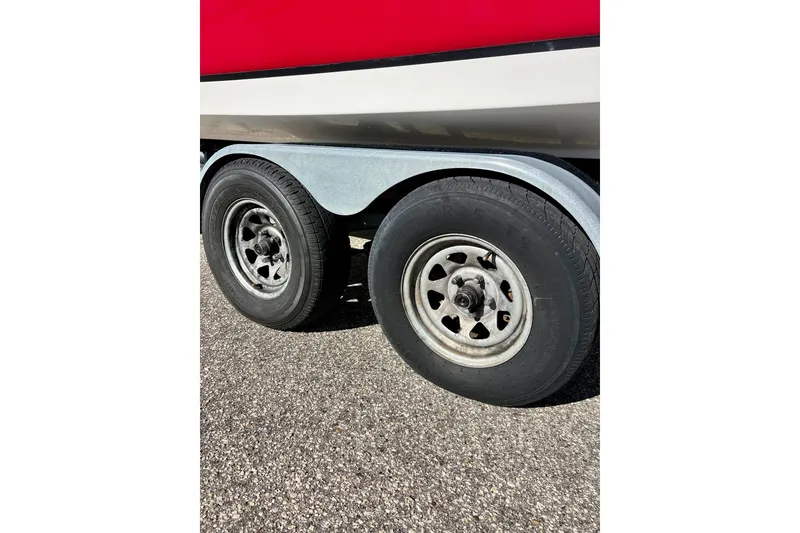 Slide: The Image of Trailer wheels of 2013 Hurricane SunDeck Sport 220 OB boat on pavement. - 8
