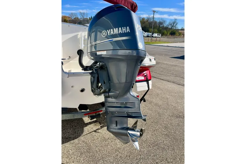 Slide: The Image of 2013 Hurricane SunDeck Sport 220 OB with Yamaha outboard motor in a parking lot. - 9