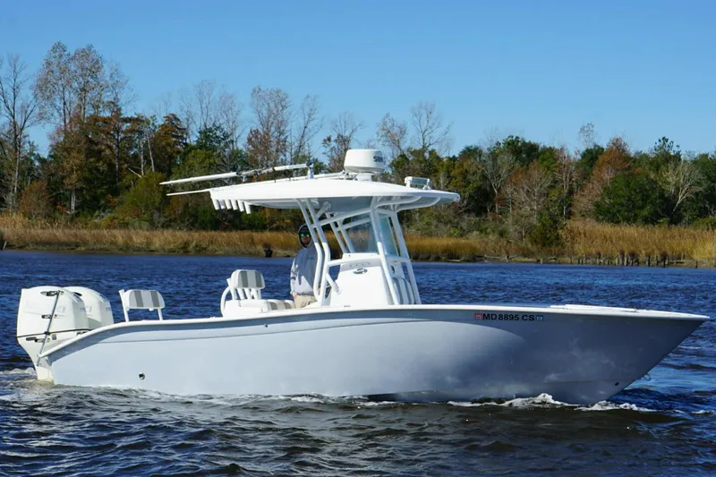 Slide: The Image of 2018 Cape Horn 24 XS boat cruising on a calm river with forested background. - 10
