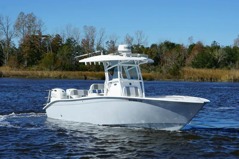 Slide: The Image of 2018 Cape Horn 24 XS boat cruising on a calm river with trees in the background. - 11