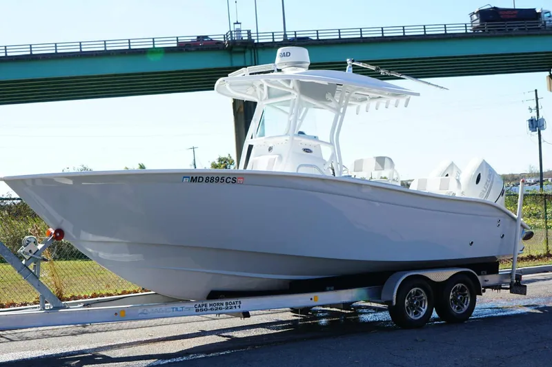 Slide: The Image of 2018 Cape Horn 24 XS boat on water, featuring a sleek design and spacious seating. - 14