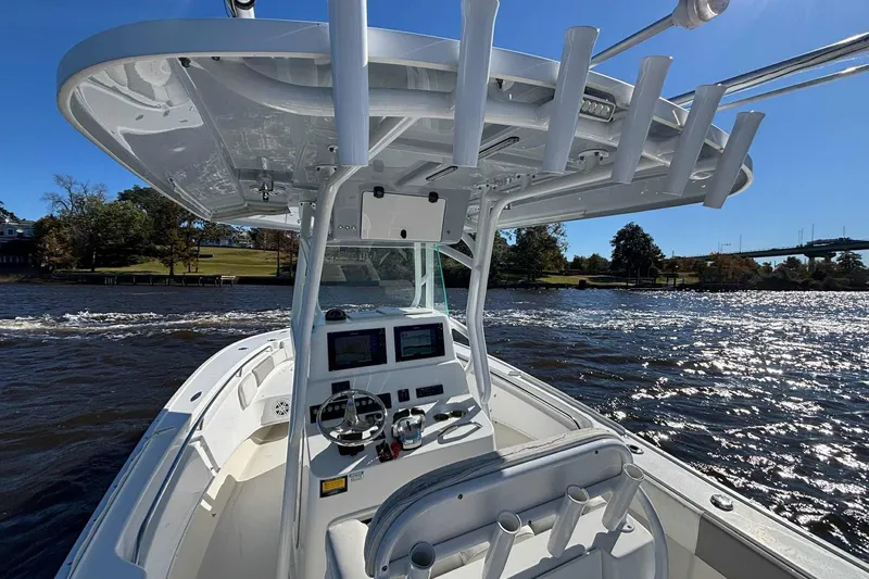 Slide: The Image of 2018 Cape Horn 24 XS boat on water, featuring modern helm and rod holders. - 20